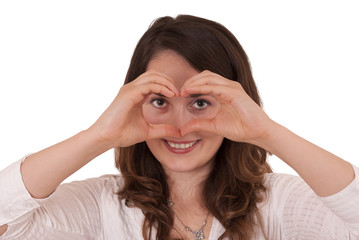 Cute young female making heart sign