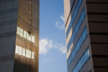 Skyscrapers at sunset creating reflections and shadows