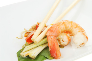 Closeup of prawns with chopsticks