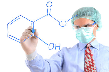 A chemist writing formula on glass