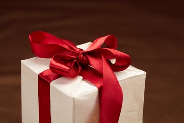 Beautiful gift box on the gold background