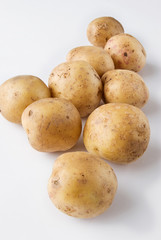 Potatoes raw over white background.