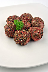 peppered meat balls with organic parsley on a plate