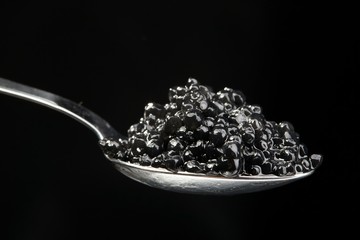 The full spoon of black caviar