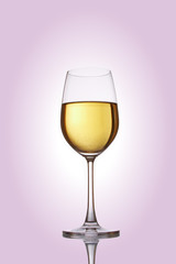 Glass with white wine on a rose background
