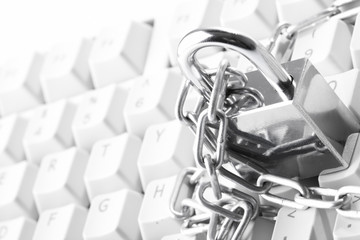 Computer  keyboard secured with chain and padlock..