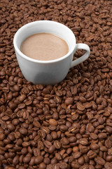 Cup with coffee, costing on coffee grain