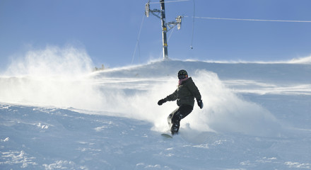 freestyle snowboarder jump and ride