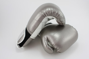 Pair of silver boxing gloves on white background