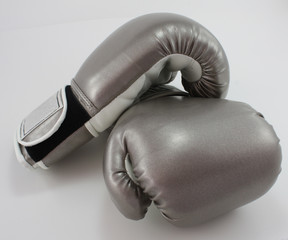 Pair of silver boxing gloves on white background