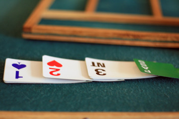 equipment to bridge playing: green tables, biding box