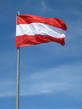 Waving Austrian flag on natural sky