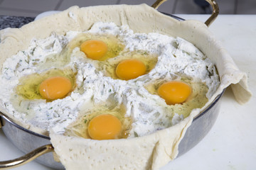 preparing pie with cheese. Eggs in stuffing.