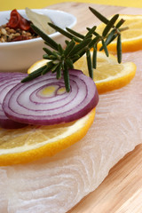raw vietnamese river cobbler fillet on a timber board