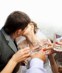 kissing newlyweds and cheers