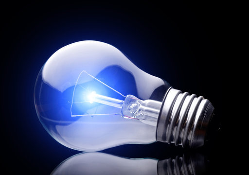 Photo of light bulb on black background.