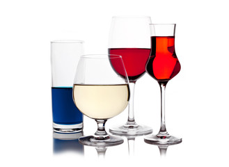 different colored drinks in wineglasses