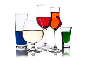 different colored drinks in wineglasses