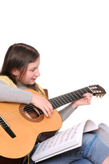 Fototapeta premium Girl learning to play guitar