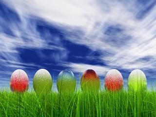 High resolution Easter eggs in grass over a blue sky