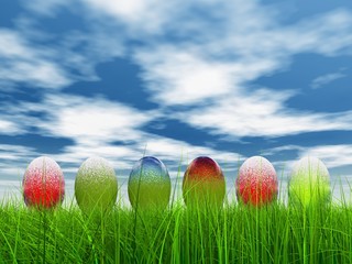 High resolution Easter eggs in grass over a blue sky
