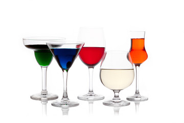 different colored drinks in wineglasses