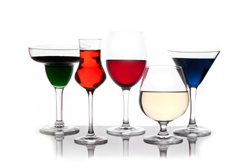 different colored drinks in wineglasses