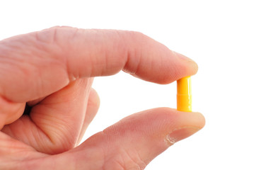 Holding a Yellow Pill (Capsule)