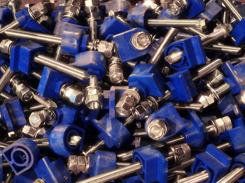 many large screws with bolts and blue plastic fasteners
