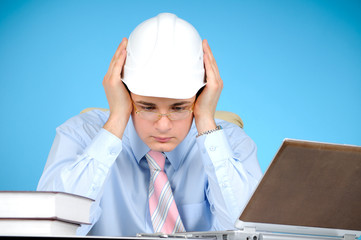 An engineer with white hard hat at work