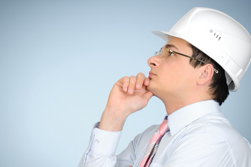 An engineer with white hard  helmet on grey background