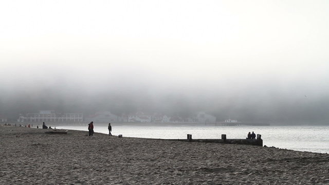 Sandy Beach with Fog and People
