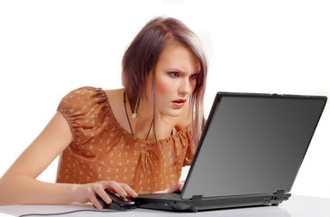 Naklejka premium Surprised young girl with laptop and head phones