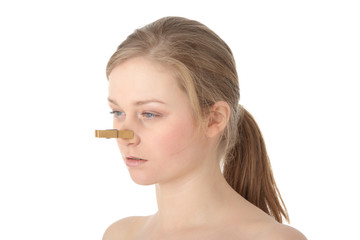 Naklejka premium Disgusted woman with clothespin clipped to nose
