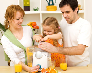 Family making fresh fruit juice together