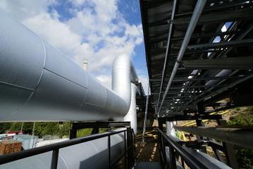 industrial pipelines on pipe-bridge against blue sky