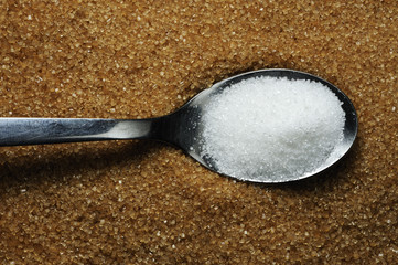 Teaspoon with brown and white sugar