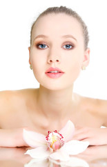 studio shot of beautiful woman with flower