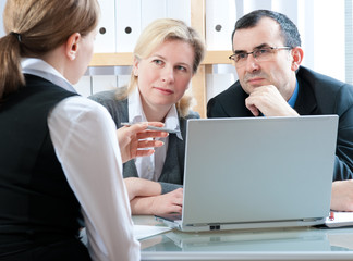 mid-adult couple meeting with financial planner