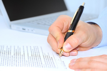 Businessman is signing a contract