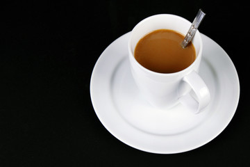A cup of coffee on a black background