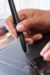 Hand using digital pen tablet