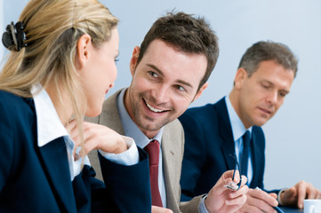 Smiling business man talking with colleagues