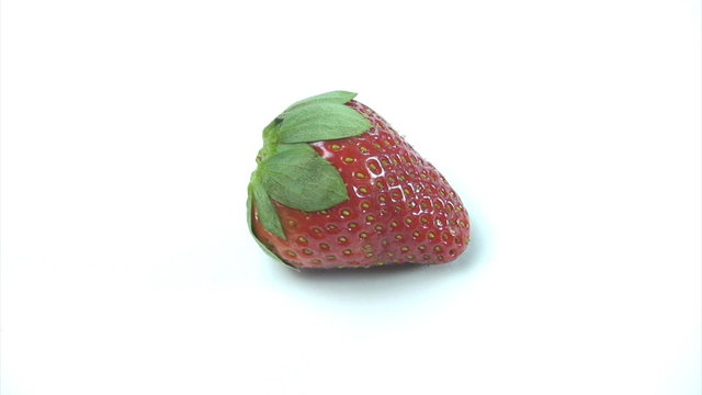 Fresh straberry spinning on a white background