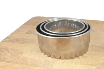 cookie cutters on chopping board