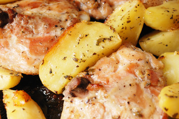 Fried chiken with potato chips closeup. Spices added.