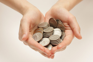 Silver coins in hands
