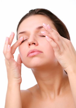 Young woman pushes with fingers on closed eyes