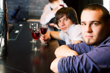 Young men relaxing on a bar counter.