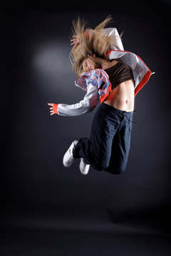 jumping woman modern dancer against black background